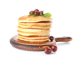 Stack of tasty pancakes with gooseberry on white background