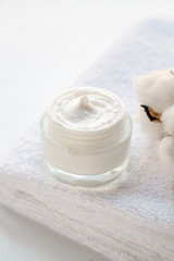 Fototapeta na wymiar Jar of natural cream on soft towel