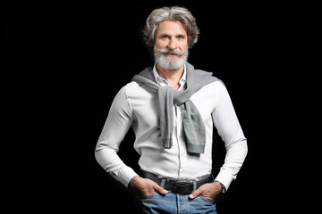 Fashionable senior man on dark background