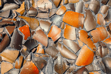 decorative ceramic pieces embedded on cement wall