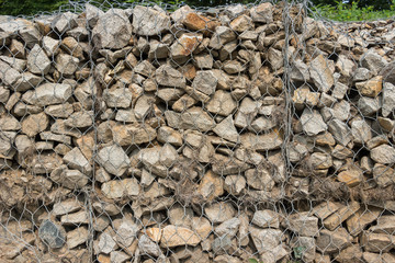 Gabion fence from mesh with stones