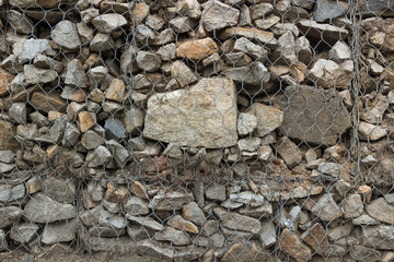 Gabion fence from mesh with stones