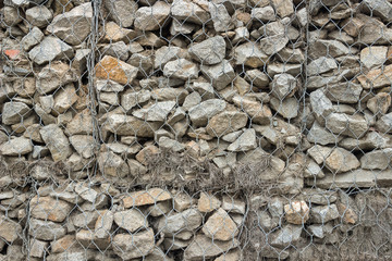 Gabion fence from mesh with stones