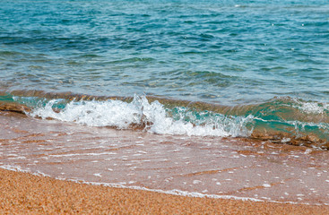 sandy beach and blue sea wave. Beautiful natural background.