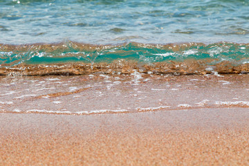 sandy beach and blue sea wave. Beautiful natural background.