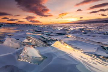 Colorful sunset over the crystal ice of Baikal lake