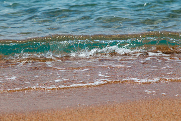 sandy beach and blue sea wave. Beautiful natural background.
