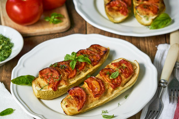Stuffed zucchini with potatoes and tomatoes