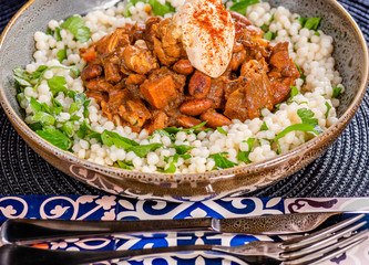 A traditional Moroccan dish called chicken Tajine featuring Saffron, Honey, Almonds, Dates, Couscous and Labneh
