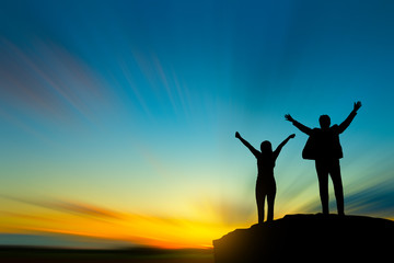 silhouette of people on mountain top over sky and sun light background,business, success, leadership, achievement and people concept