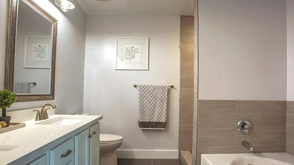 Panorama Bathroom interior with a bathtub in front of thee vanity area and mirror