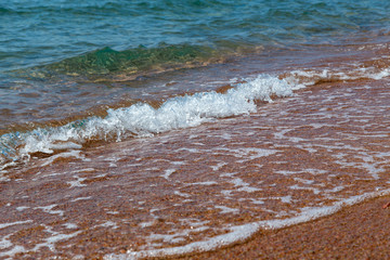 sandy beach and blue sea wave. Beautiful natural background.