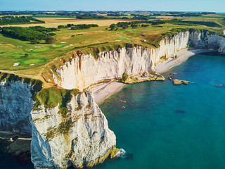 Picturesque landscape of white chalk cliffs and natural arches of Etretat, France