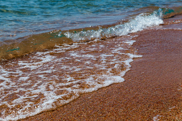sandy beach and blue sea wave. Beautiful natural background.