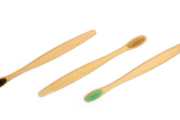 Top view of bamboo toothbrushes on white background.