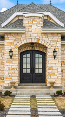 Vertical Home facade with stone brick wall double glass paned door and arched windows