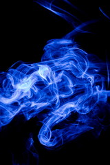 Blue smoke on black background