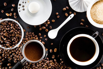 Coffee scene flat lay beans porta filter black coffee cup sugar and macaroon biscuit