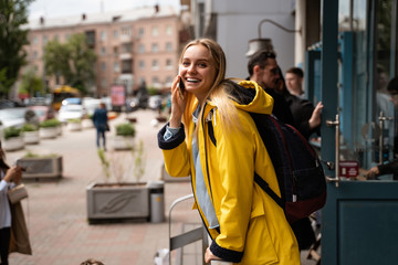 Fototapeta premium Woman walking and using a smartphone in the street