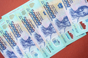 Five hundred thousand dong banknotes on a brown background close-up. Vietnamese money