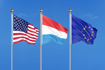Three colored silky flags in the wind: USA (United States of America), EU (European Union) and Luxembourg. 3D illustration.