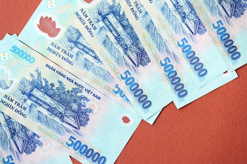 Five hundred thousand dong banknotes on a brown background close-up. Vietnamese money