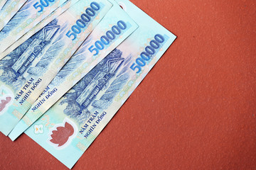 Five hundred thousand dong banknotes on a brown background close-up. Vietnamese money
