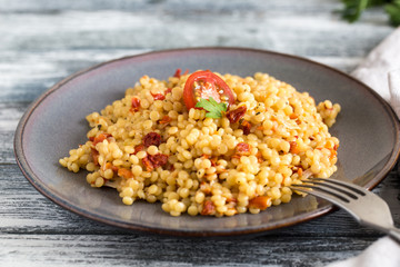 Ptitim or Birdy, Israeli pasta couscous  with tomatoes and herbs
