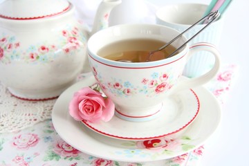 cup of tea and pink rose 