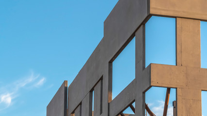 Panorama Close up of the exterior of a building under construction against cloudy sky