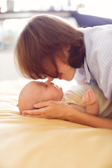 Caucasian Tender mother and baby, gently touches