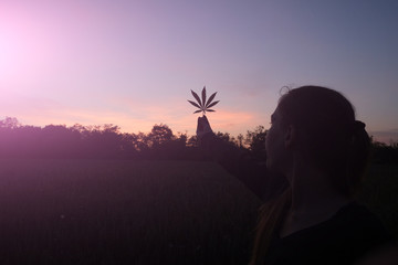 Woman holding cannabis leaf