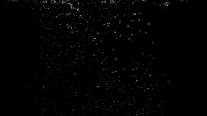 Water bubbles floating after splash underwater and black background which represent freshness of carbonate drink such as cola or soda and refreshing feeling of food product and texture.