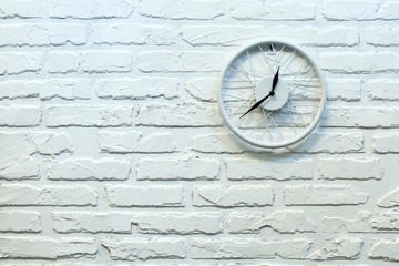 Clock in white brick wall. Background. Texture. Brick.