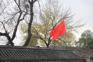 Chinese flag on the roof of an old house