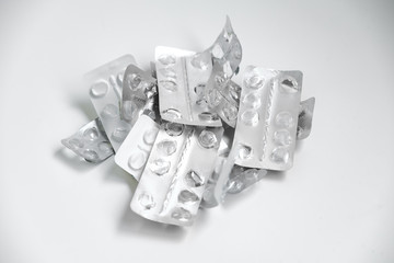 Used drugs, Used capsules, Used antibiotic packaging on white background, Close-up of empty pill package