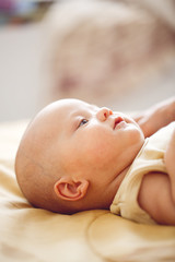 4 month baby on bed in bedroom in bright interior