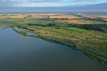 Drone aerial perspective view on agricultural part of Jamni Lake with fields and meadows