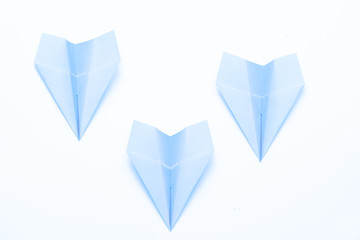 Business failure and crisis. Three sky blue paper airplanes isolated on white background. Copy space.