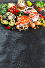 Pescetarian diet plan ingredients, healthy balanced grocery food, fresh fruit, berries, fish and shellfish clams,  black background copy space 