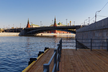Fototapeta na wymiar View of Bolshoy Kamenny Bridge above Moskva river against towers of Moscow Kremlin on a blue sky background in sunny morning