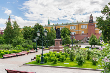 View of Aleksandrovskiy garden near walls of Moscow Kremlin on a background of blue sky with white...