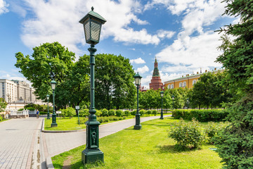 View of Aleksandrovskiy garden near walls of Moscow Kremlin on a background of blue sky with white clouds in sunny summer morning