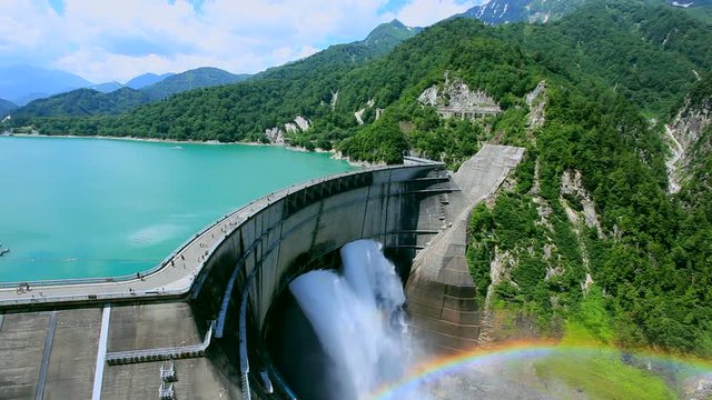 Kurobe Dam with forested mountains in background
