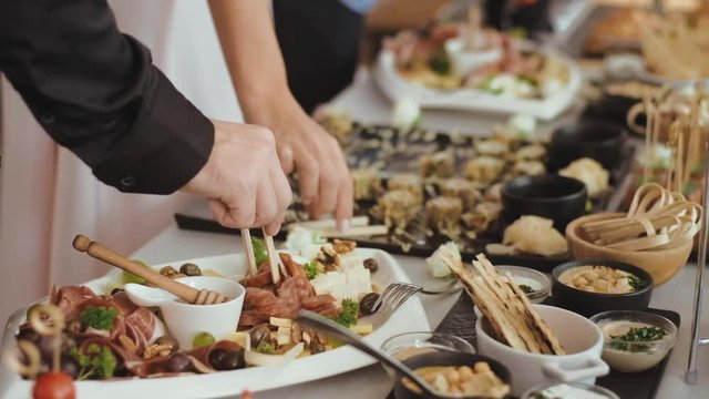 Delicious snacks and appetizers on feast table.  Party celebration, wedding concept.  Restaurant catering  with canapes  at a buffet.
