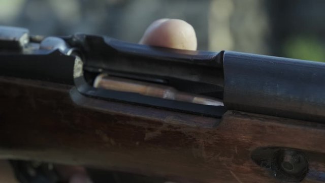 Male hunter in ready to hunt. The man is on the hunt, sport. Hunter man. Hunting period. Male with a gun, rifle. Man is charging a hunting rifle