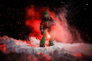 Active female snowboarder dressed in a green sportswear standing on the snow slope