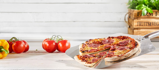 Panorama banner with a traditional salami pizza