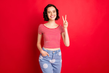 Photo of smiling cheerful girl willing to shine her beauty on all of you while isolated with red...