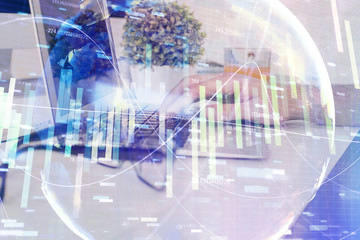 Double exposure of businessman working on laptop on background. International business hologram in front. Concept of success.